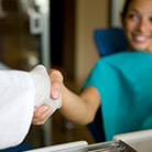 Girl shaking hands with her dentist