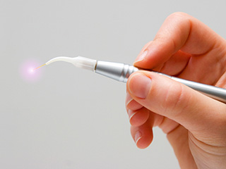 Hand holding a soft tissue laser