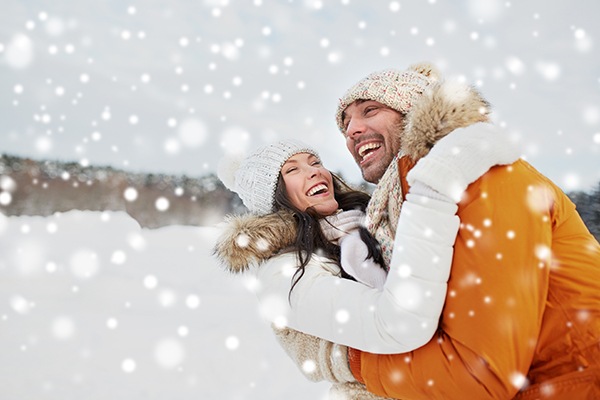 smiling couple in the snow