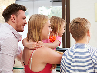 Smiling family looking out window