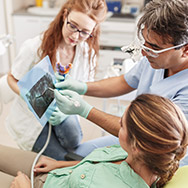 Dentist showing x-rays to patient