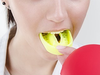 Closeup of young girl placing dental mouthguard