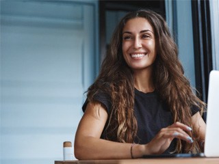 Woman at work wearing dentures in Edison