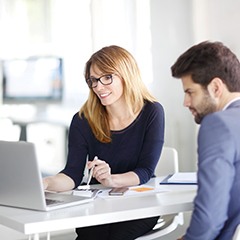 man and woman looking at a laptop together