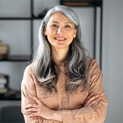 Senior woman smiling with her arms folded