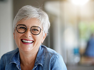 Woman with dentures in Edison