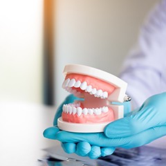 dentist holding dentures