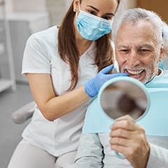 man smiling after getting dentures