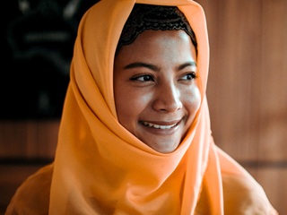 person wearing a hijab and smiling