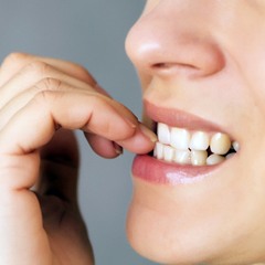Person biting their nails with their teeth