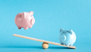 Piggy banks on balance scale