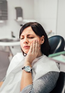 Woman with toothache at dentist's office