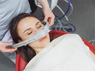 Patient breathing in nitrous oxide through nasal mask