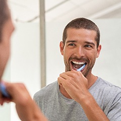 Man brushing teeth to prevent dental emergencies in Edison, NJ