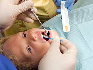 Young child receiving fluoride treatment