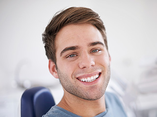 Smiling man in dental chair