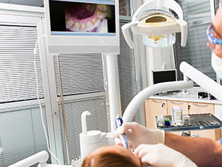 Patient and dentist looking at intraoral photos