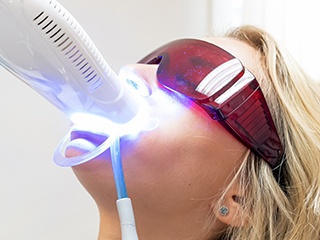 a patient undergoing in-office teeth whitening in Edison