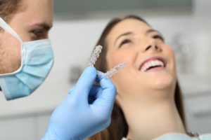 dentist holding invisalign