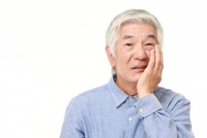 man with toothache needs to visit emergency dentist in Edison