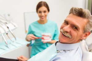 elderly man getting dentures in Edison 