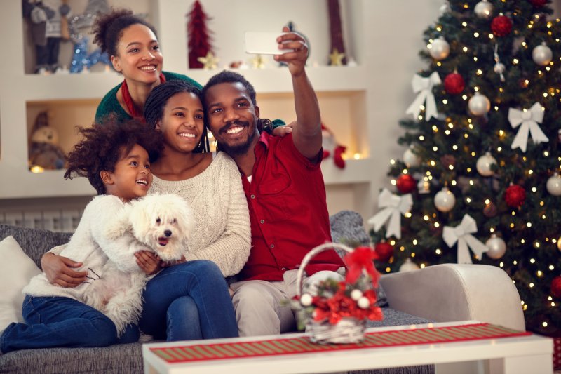 family smiling and taking selfie