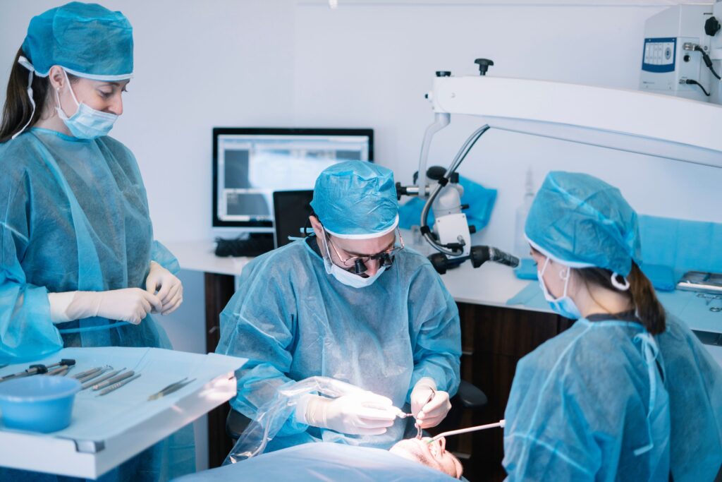 Dentist performing oral surgery on patient