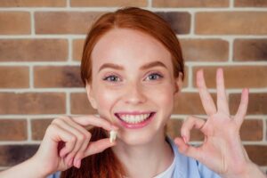 Woman smiling after her tooth extraction