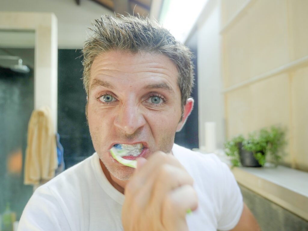 Man brushes teeth